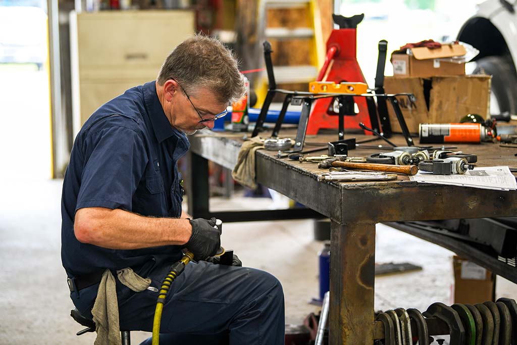 Worker using shop tools.